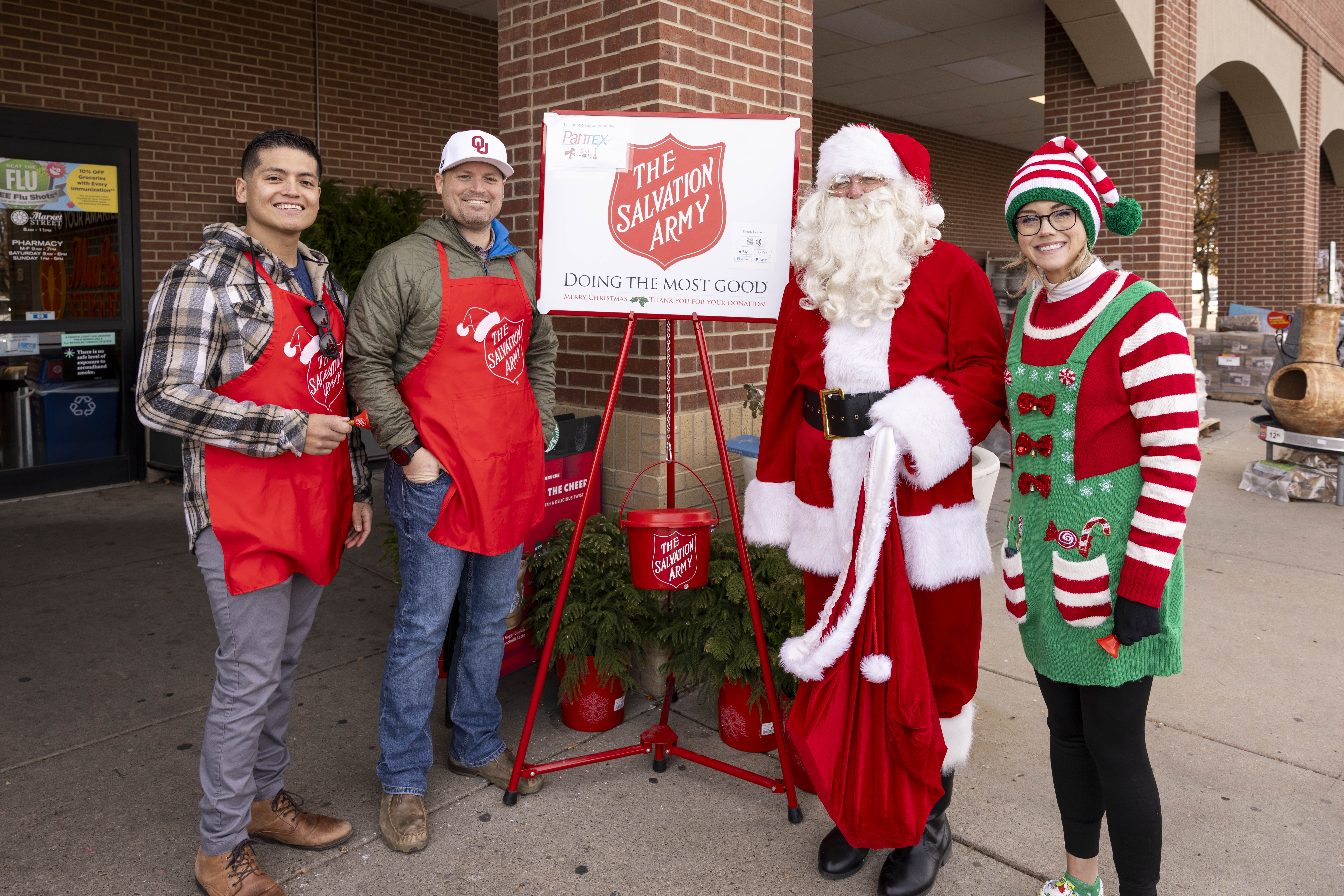 Volunteers ringing bells outside store for The Salvation Army’s Red Kettle Campaign. Volunteers ringing bells outside store for The Salvation Army’s Red Kettle Campaign.