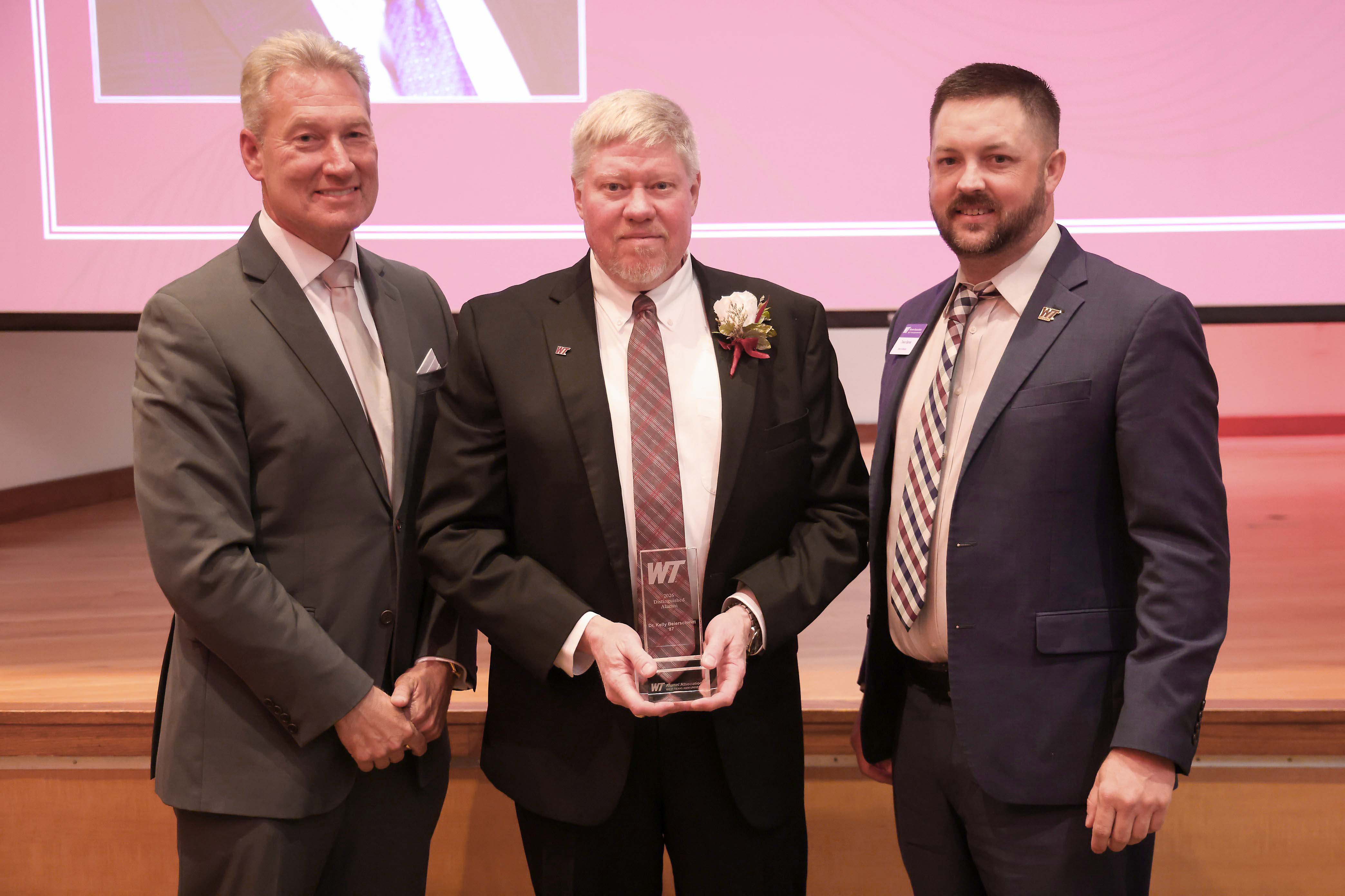 PXD President and General Manager Kelly Beierschmitt (center) receiving the 2026 WT Distinguished Alumni Award with WT Interim President Neil Terry (left) and WT Alumni Association Board President Trevor Barnes (right). Photo provided by West Texas A&M University. PXD President and General Manager Kelly Beierschmitt (center) receiving the 2026 WT Distinguished Alumni Award with WT Interim President Neil Terry (left) and WT Alumni Association Board President Trevor Barnes (right). Photo provided by West Texas A&M University.
