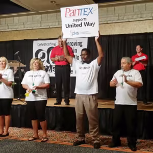 Clarence Rashada holds up a sign expressing Pantexan support during the United Way