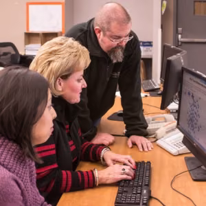 Maribel Martinez, Brenda Graham and Greg Roddahl learn about EMInS