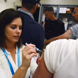 Tiffany Shadle administers a flu shot 