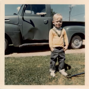 Brian Fowler, mid 1960s in front of his dad’s truck in Pantex Village
