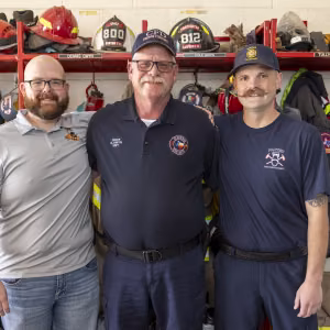 Wyatt (left) and Cole Gwyn (right) pose with their dad Dennis (middle). 
