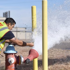 Firefighters test hydrants annually to verify operational conditions and document flow rate. 