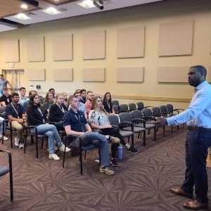 CNS interns and co-op students are pictured at a 2023 seminar featuring Jahleel Hudson, Director of NNSA’s Office of Technology and Partnerships.